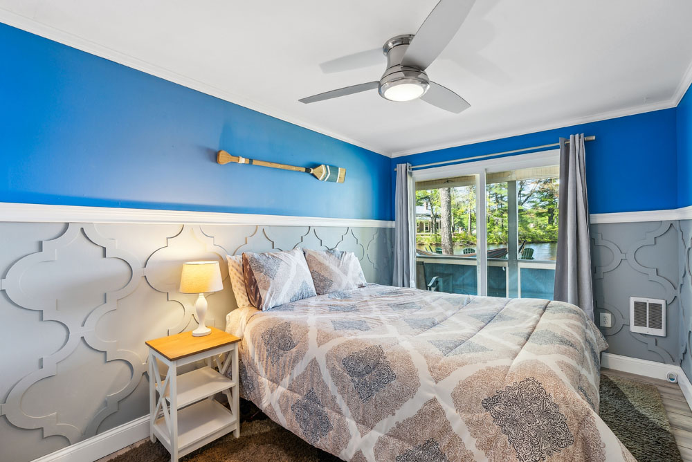 Lower level bedroom with slider door access to lake and patio. Queen bed and full closet.