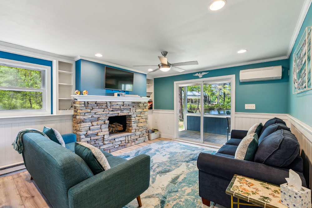Lower living room with 1 sleeper sofa and access to the lower patio and backyard to lake